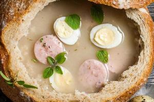 Sour soup in bread with marjoram photo