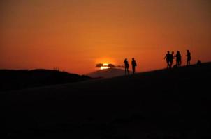 Silhouette of Sunset in Red Sand Dunes, Mui Ne, Vietnam photo