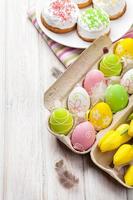 Pascua con tulipanes amarillos, huevos coloridos y pasteles tradicionales foto