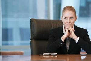 Confident Businesswoman At Conference Table