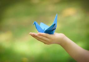 paper crane on little girl's hand