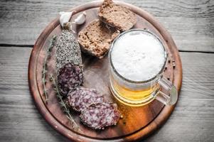 Slices of french saucisson sausage with glass of beer photo