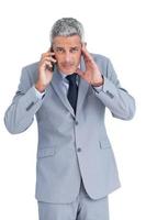 Concentrated businessman answering phone