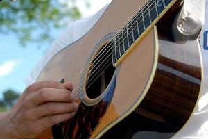 Person playing a guitar outdoors photo