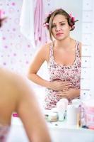 Young teen girl having period cramps photo