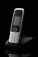 Cordless telephone on black background photo