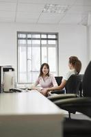 Businesswomen Conversing In Office photo