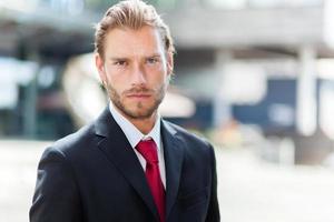 Young businessman looking at the camera outdoor photo
