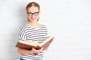 Happy successful student girl with book photo