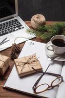 Cup of coffee with notebook and gifts photo