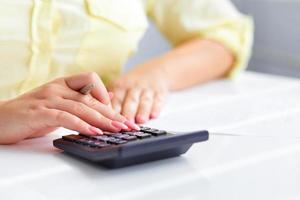 Woman's hands with a calculator