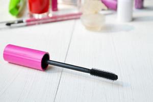 Pink mascara stick, eyeliner, lipstick, pencil and other cosmetics