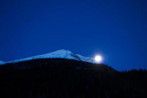 View at moon through the mountains photo