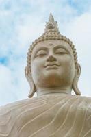 Buddha status on blue sky background photo