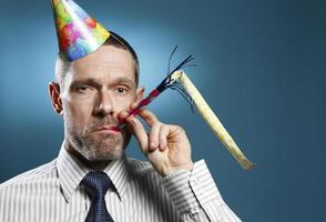 Man Wearing Tie With Party Hat And Horn Blower
