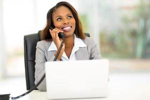 african american businesswoman making phone call photo