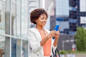 happy african businesswoman with smartphone photo