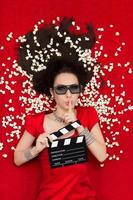 Girl with 3D Glasses, Popcorn and Clapboard Asking for Silence photo