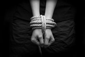 Hands of a missing kidnapped, abused, hostage, victim woman tied photo