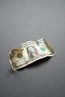Crumpled one dollar on a black