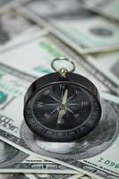 compass placed on U.S. Dollar banknotes photo