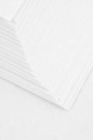 close up of stack of papers on white background photo