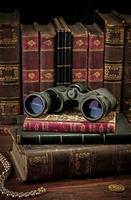 Binoculars and old books