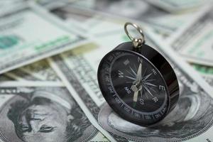 compass placed on U.S. Dollar banknotes photo