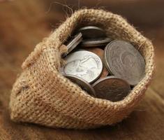 Old coins in sack bag photo