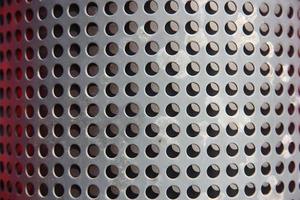 metal holed or perforated grid background photo