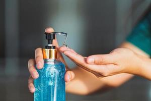A person uses hand sanitizer at home photo