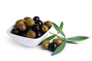 Green and black olives in bowl isolated on white