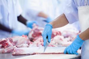 butcher chopping pork meat photo