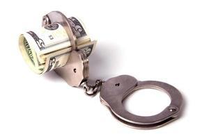 Steel handcuffs and a roll of dollars photo