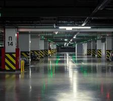 Parking garage, underground interior with a few parked cars photo
