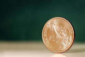 American One Dollar Coin over Green Background photo