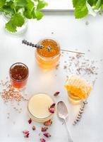 Honey variaty with bee's comb in a glass jurs photo