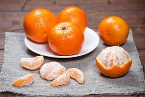 Tangerines on wooden table photo