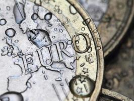 euro coin detail with rain drops photo