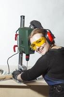 female carpenter and drilling machine.