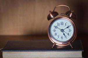 Alarm clock and book. photo