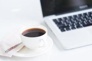 Coffee cup and laptop for business photo
