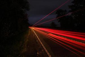 Long exposure vehicle lights country road photo