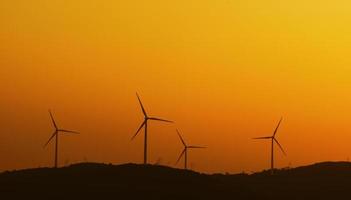 Wind turbines with power line in the sunset
