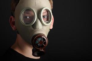 Man with gas mask on black  background