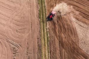 aerial view of  of tractor on harvest field photo