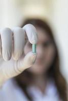 Doctor holding blue pill capsule