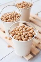 health food-soybean, soy pods in white bucket on wooden board photo