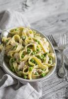homemade pasta with green peas, chicken and cream sauce
