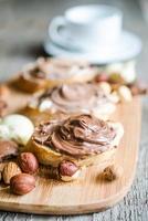 Slices of bread with chocolate cream and nuts photo